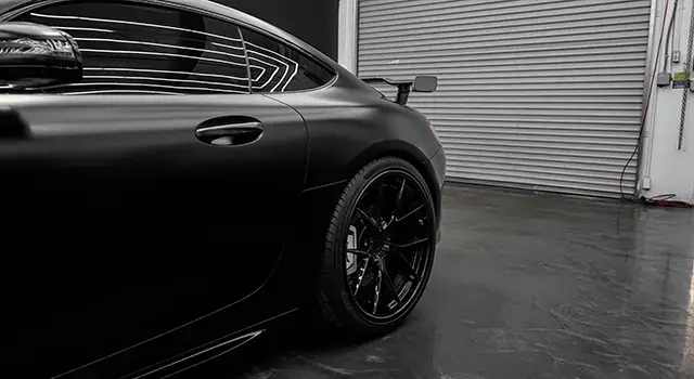 Porsche 911 with a fresh matte black finish.